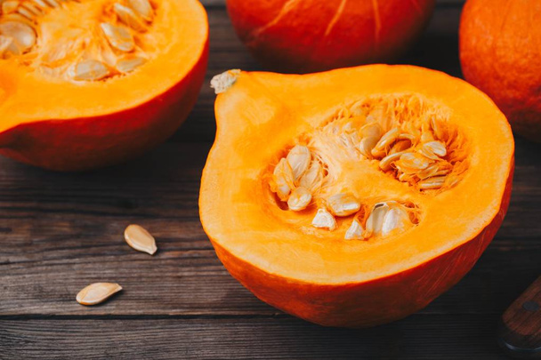 raw pumpkin slices with seeds on a wooden background. - Photo, Image
