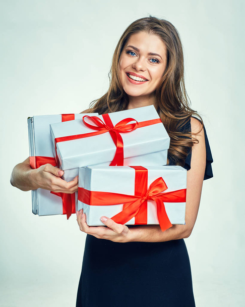 Smiling woman holding gift boxes - Фото, изображение