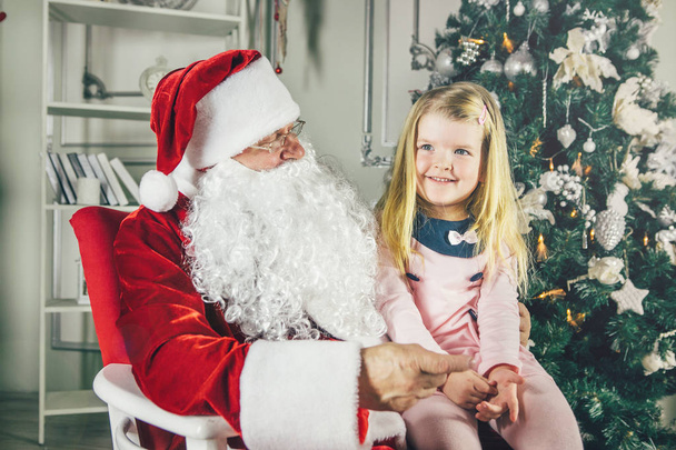 Little girl sitting with Santa  - Φωτογραφία, εικόνα