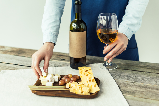  sommelier taking glass of wine and cheese - Fotó, kép
