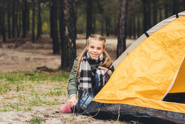 child installing camping tent - Foto, imagen