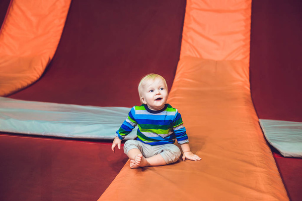 Cute little boy on a trampoline in a trampoline center. - Φωτογραφία, εικόνα