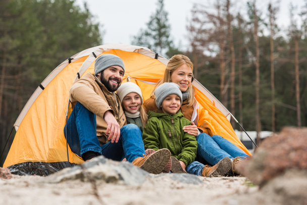 family sitting near tent - Foto, imagen