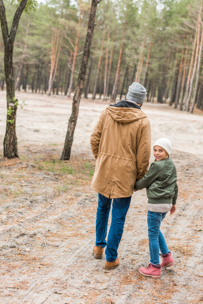 father and daughter walking by forest - Valokuva, kuva