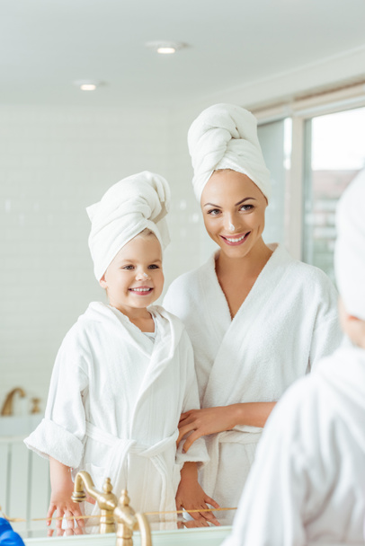 mother and daughter in bathrobes - Photo, Image