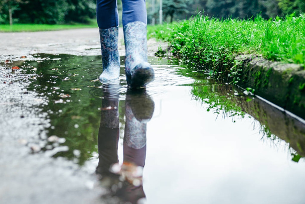 woman legs walking by puddle - Photo, Image