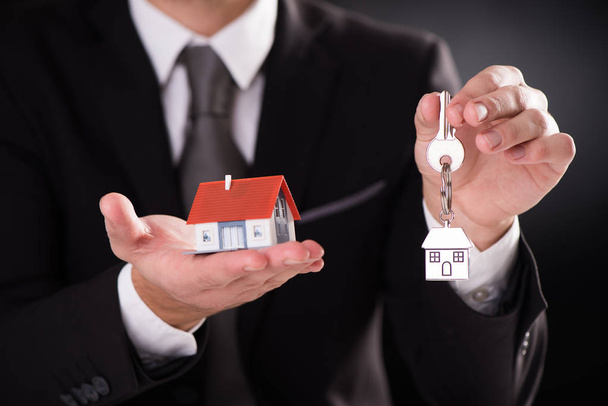 Small house and keys on palm of hand - Photo, Image