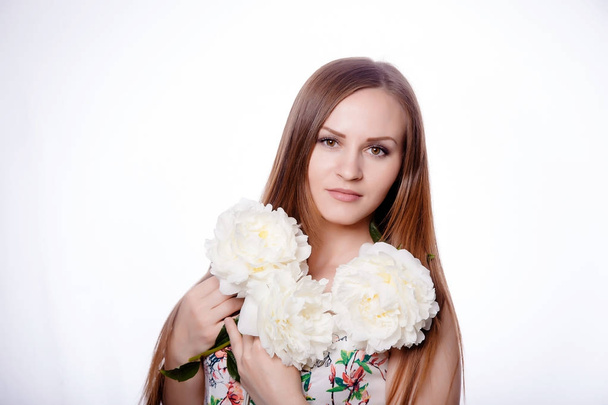 Beautiful girl with peony flowers - Фото, изображение
