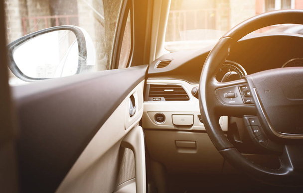 steering wheel in the light interior of the car - 写真・画像