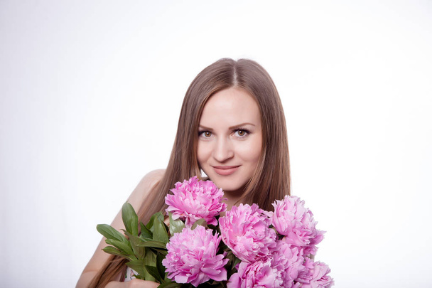 Beautiful girl with peony flowers - Fotografie, Obrázek