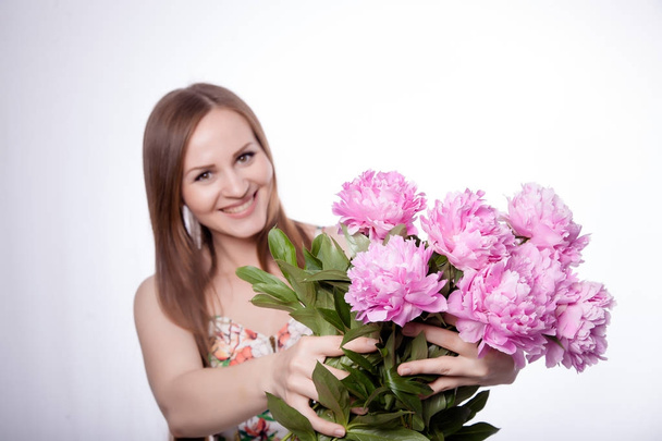Beautiful girl with peony flowers - Valokuva, kuva