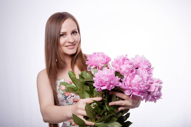 Beautiful girl with peony flowers - Фото, зображення