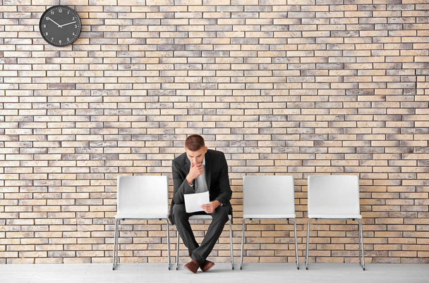 Young man waiting for job interview in hall - Photo, Image