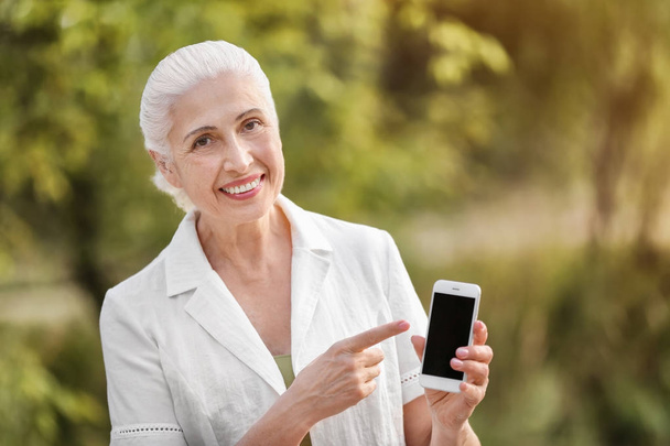 Senior woman with mobile phone - Фото, изображение