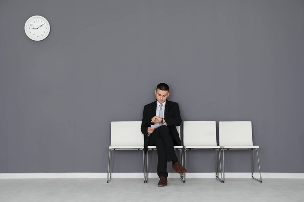 Young man waiting for job interview in hall - Foto, Imagem