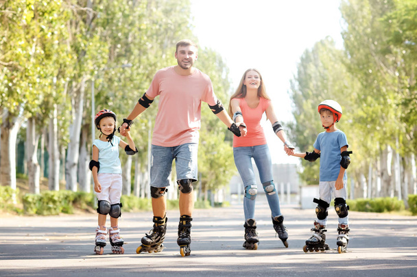 Family rollerskating in park - Photo, Image