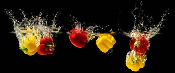 Group of bell pepper falling in water - Photo, image