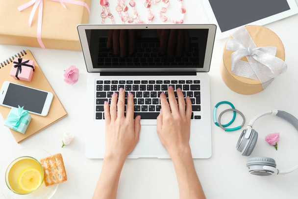 Hands of beauty blogger with laptop and different stuff on table - Фото, изображение
