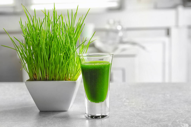 Sprouted wheat and shot of healthy grass juice on table - Zdjęcie, obraz