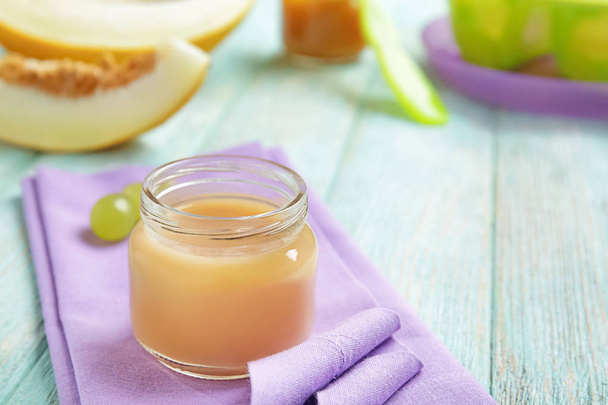 Jar with tasty baby food on table - Photo, image