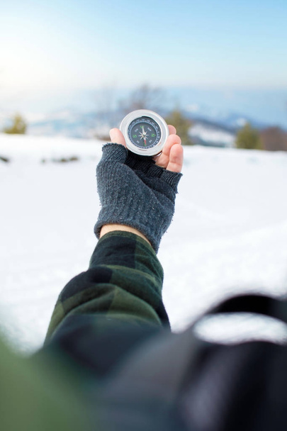 Man holding a metal compass on mountain - Photo, Image