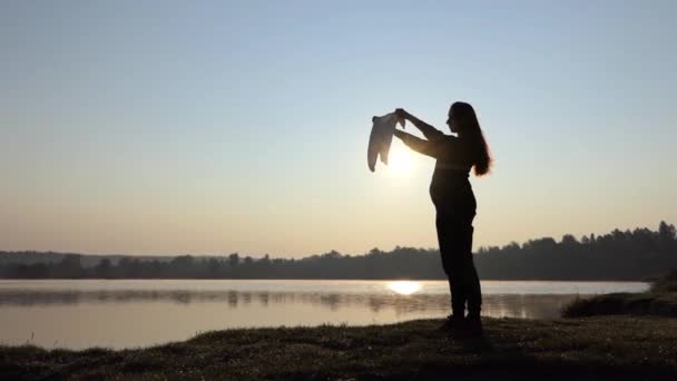 Беременная женщина играет с детским телом на закате осенью
 - Кадры, видео