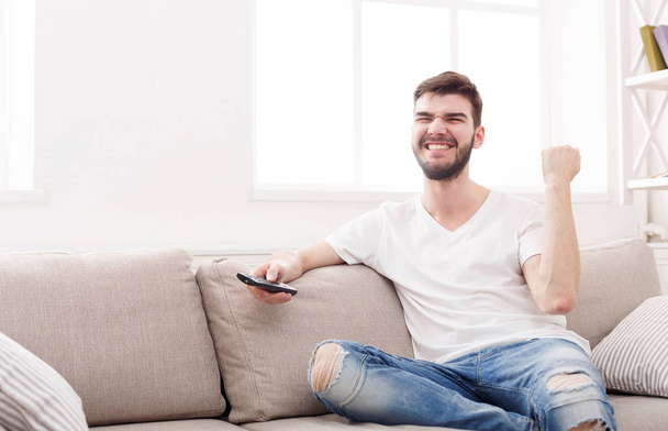 Man watching sports on tv and supporting team - Photo, Image