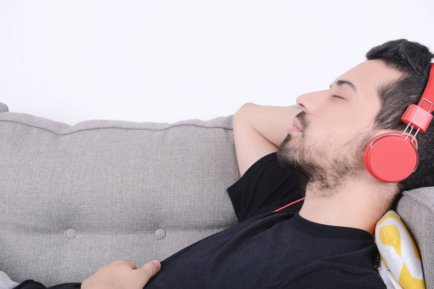 Man listening music on couch. - Photo, Image