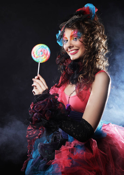 woman with creative make-up in doll style with candy. - Фото, изображение
