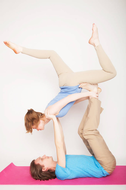 lifestyle, sport  and people concept: Young couple in yoga pose - Фото, изображение