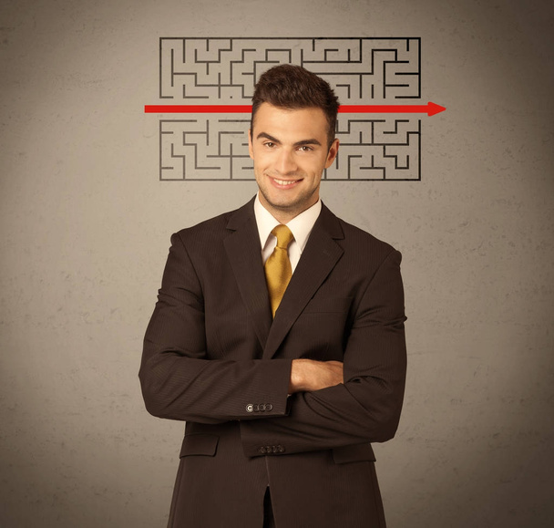 Handsome business guy solving maze - Foto, imagen