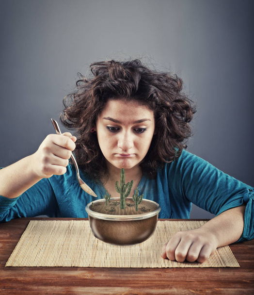 Young woman have to eat a bowl  - Photo, Image