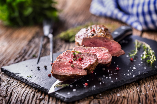 Beef Steak. Roasted Beef steak with salt pepper thyme on rustic wooden table - Photo, image