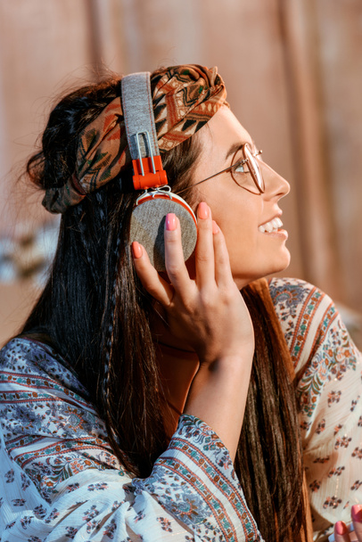 hippie girl listening to music in headphones - Photo, image