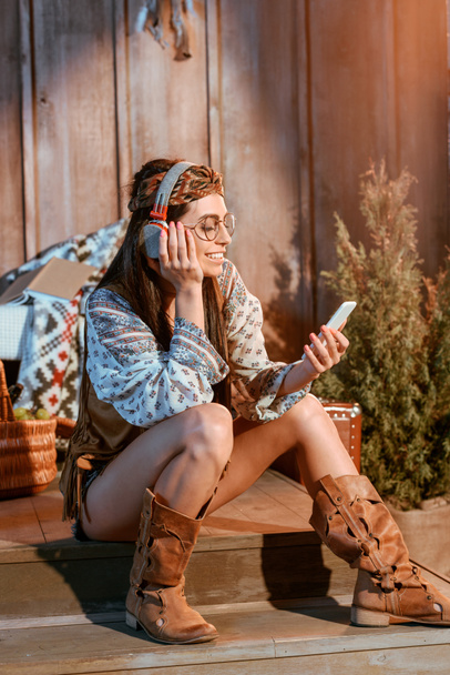 woman in boho style listening to music - Photo, Image