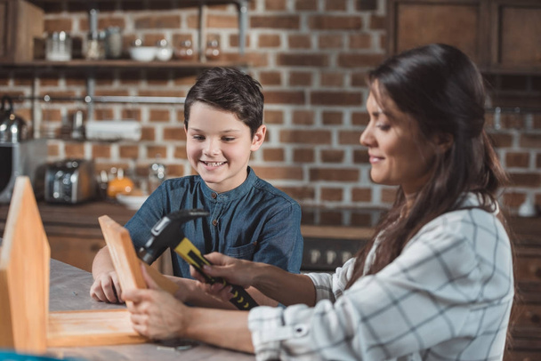 Mother and son building birdhouse - Photo, Image
