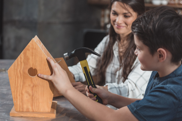 Mother and son building birdhouse - Photo, Image