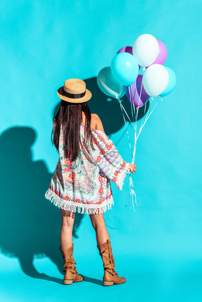 Hippie woman holding colored balloons  - 写真・画像