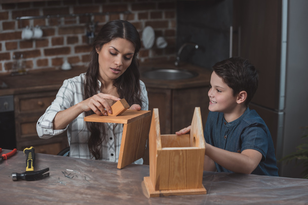 Mother and son workign on birdhouse - Photo, Image