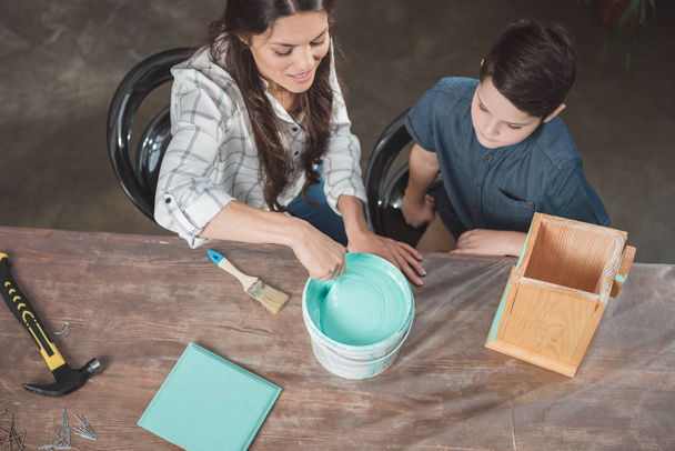 Mother and son painting birdhouse - Photo, Image