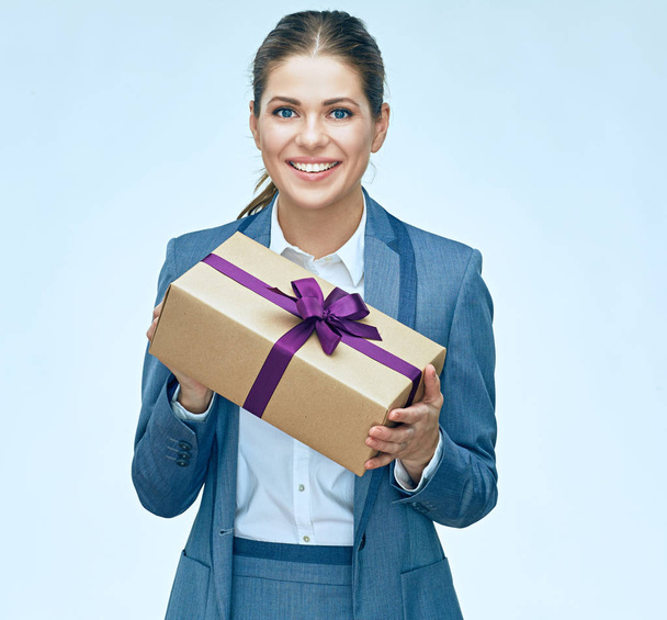 Young business woman standing with gift box against white backgr - Fotoğraf, Görsel