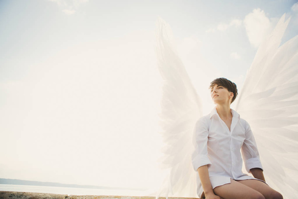 Young woman with white wings  - 写真・画像