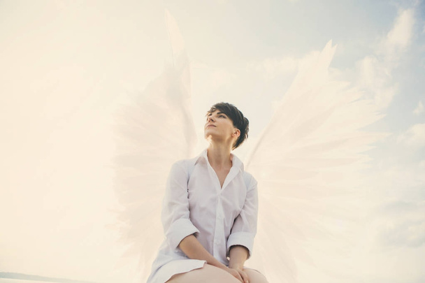 Young woman with white wings  - 写真・画像