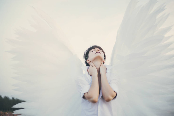 Young woman with white wings  - Foto, imagen