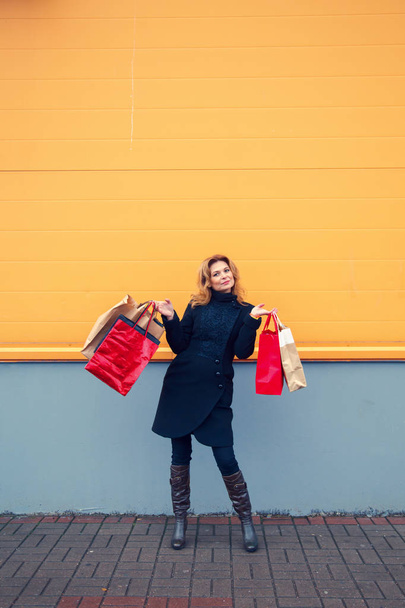 Beautiful woman with shopping bags. - 写真・画像