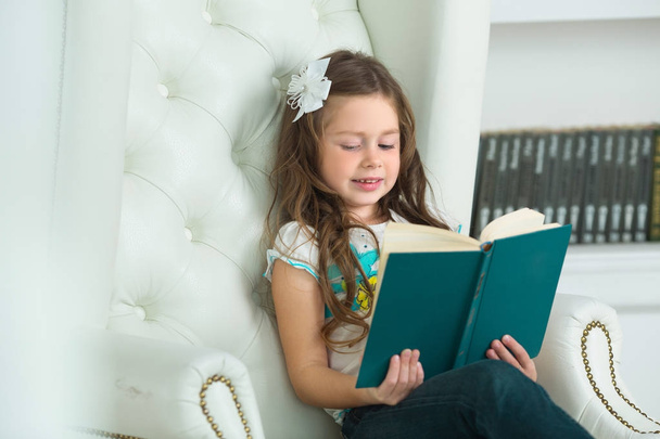 beautiful young girl reading a book - Photo, image