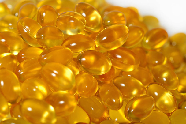 Omega-3 fish fat oil capsules as background texture - Photo, Image