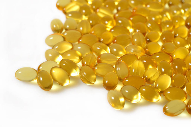 Omega-3 fish fat oil capsules close up on a white background. - Valokuva, kuva