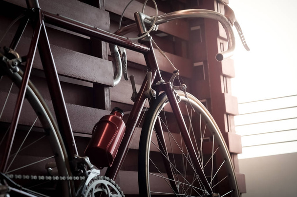 Bicycle leaning against the wall fence in the dark vintage tone. - Photo, Image
