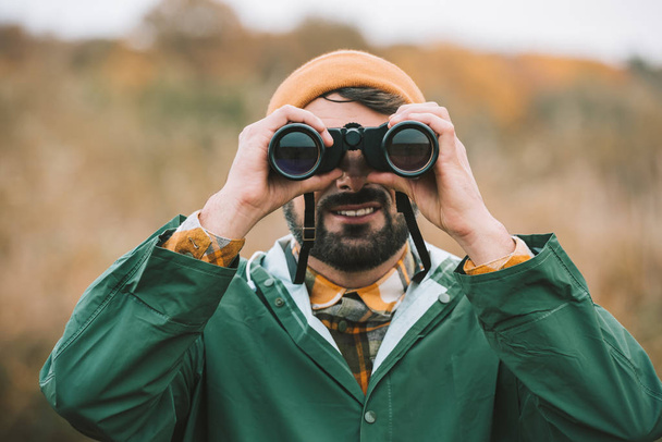 man looking through binoculars - Photo, Image